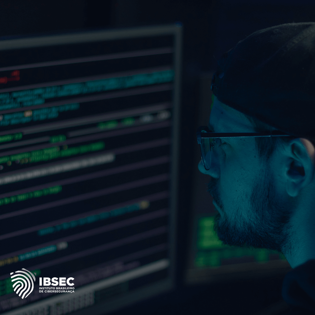 Homem usando boné e óculos, focado em uma tela de computador com linhas de código. A imagem reflete um ambiente de cibersegurança e análise digital. No canto inferior esquerdo, o logotipo do IBSEC (Instituto Brasileiro de Cibersegurança) está presente.